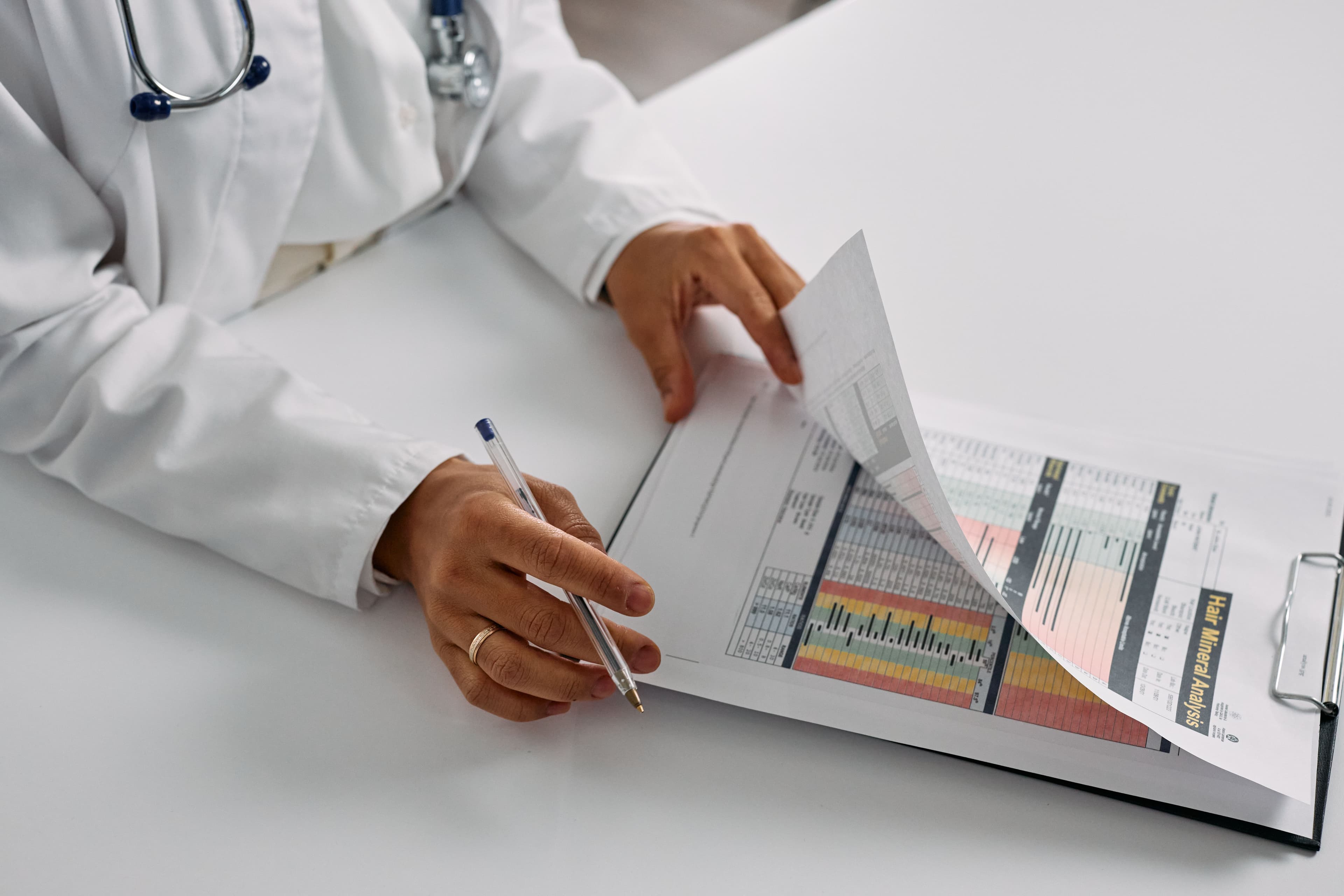 A healthcare professional reviewing printed health reports